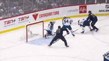 a hockey game is being played in front of a banner that says canada life