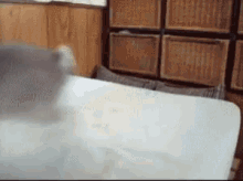a person is laying on a bed in a room with wicker baskets behind them .