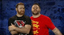 two men wearing red shirts that say classy freddie