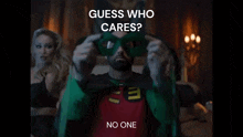 a man in a robin costume is wearing a green mask with the words guess who cares no one below him