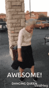 an older woman is dancing in front of a brick wall with the words awesome dancing queen