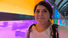 a woman taking a selfie in front of a purple wall