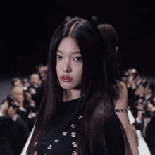 a woman with long hair is walking down the runway