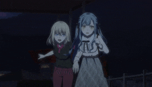a couple of anime girls standing next to each other at night