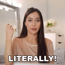 a woman says literally in front of a mirror with a ring on her finger