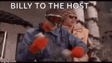 a couple of men wearing goggles and gloves are standing next to each other in a snowy area .