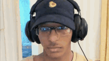 a man wearing headphones and a hat with a circle on it
