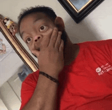 a man wearing a red shirt that says bet on em