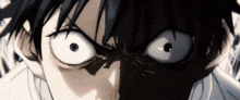 a close up of a person 's face with big white eyes and a shadow behind them .