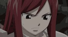 a close up of a girl 's face with a surprised expression