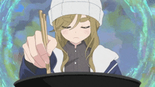 a girl in a beanie is holding chopsticks over a pot