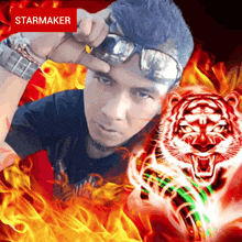 a man wearing sunglasses stands in front of a tiger in flames with a starmaker sticker above him