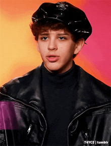 a young man wearing a police hat and a black jacket
