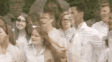 a blurry picture of a group of people standing next to each other in a line .