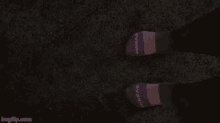 a person wearing bombas socks standing on a carpet