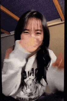a girl wearing a white shirt that says ' defense ' on it