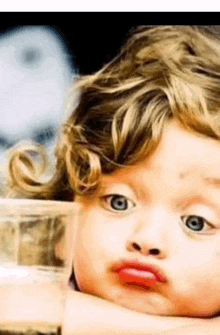 a close up of a child making a face