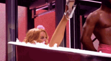 a woman is sitting in a bathtub with her leg up
