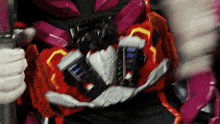 a close up of a person wearing a red and black costume with a belt that says ' samurai ' on it