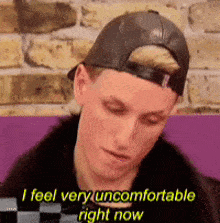 a man wearing a hat says i feel very uncomfortable right now