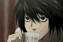 a close up of a person drinking a cup of coffee from a cup .