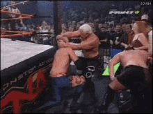 a group of wrestlers are fighting in a wrestling ring with j.j.am written on the bottom