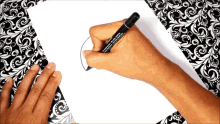 a person is writing on a piece of paper with a marker that says " permanent marker " on it