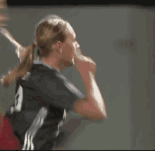 a female soccer player wearing a number 9 jersey is giving a thumbs up .
