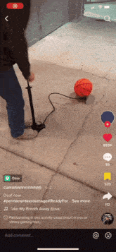 a person is pumping a basketball on a concrete surface