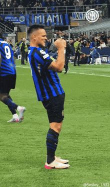 a soccer player with the number 9 on his back stands on the field
