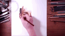 a drawing of a man 's face is being drawn with a pencil that says prismacolor