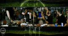 a man wearing a number 7 jersey sits at a table with two babies