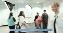a group of people are standing in a room with a banner that says jiu