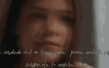 a close up of a woman 's face with a quote written on the bottom of it .