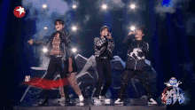 a group of people singing on a stage with a star on the bottom right