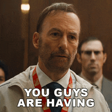 a man says you guys are having while wearing a lanyard
