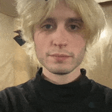 a close up of a man 's face with a wig on