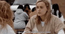 a woman is sitting at a table talking to another woman and saying i want to cry and throw shit and kill myself