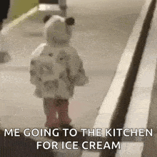 a little girl is walking down a sidewalk with the words `` me going to the kitchen for ice cream '' written on it .