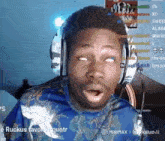 a man is wearing headphones and making a funny face .