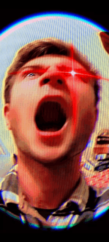 a close up of a man 's face with red eyes