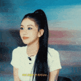 a woman with long black hair is wearing a white nike t shirt