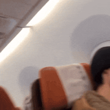 a blurry picture of a person sitting in an airplane