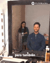 a man is getting his hair done in front of a mirror that says panorama on it