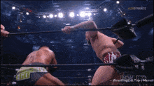 two men are wrestling in a ring with aaew dynamite written on the bottom