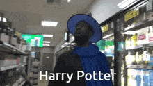 a man wearing a blue cape and a blue hat says harry potter in a store