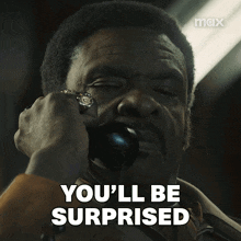 a man talking on a phone with the words " you 'll be surprised " above him