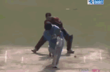 a cricket game is being played in front of a large mrf sign