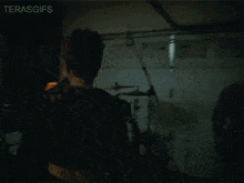 a woman with red hair is dancing in front of a drum set and the words terasgifs are on the bottom right