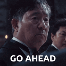 a man in a tuxedo says go ahead